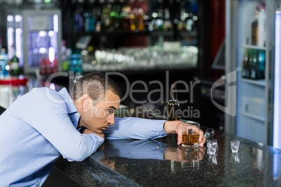 Depressed man having alcohol