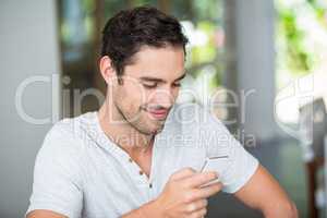 Smiling man using smartphone