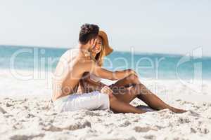 Young couple sitting on sand