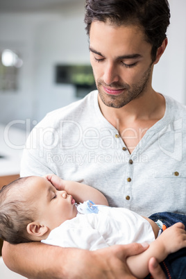 Father carrying sleeping baby