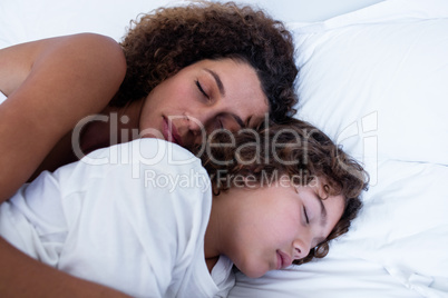 Close-up of mother and son sleeping together