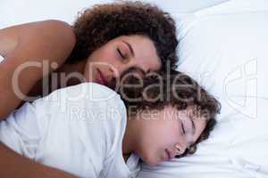 Close-up of mother and son sleeping together