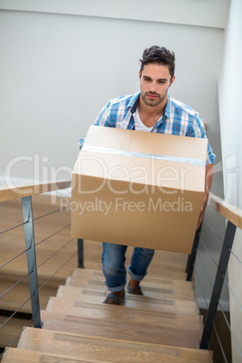 Handsome man holding cardboard box Handsome man holding cardboard box