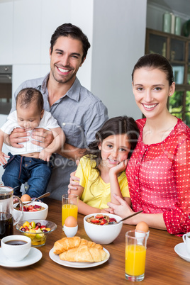 Portrait of smiling family at breakfast table