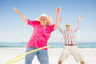 Senior couple doing hula hoop