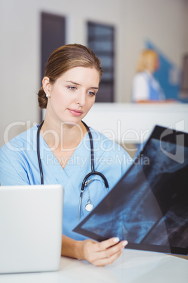 Female doctor holding X-ray