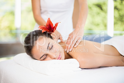 Young woman receiving massage at health spa