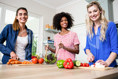 Beautiful female friends preparing food