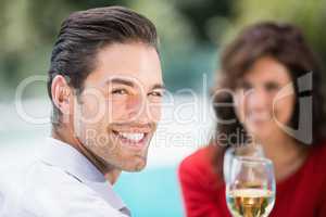 Portrait of young man toasting white wine