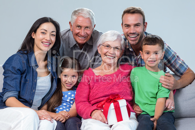 Family giving a gift to grandmother