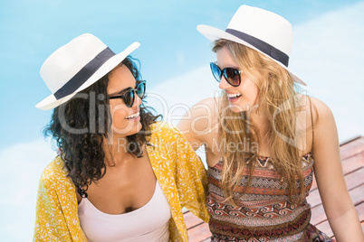 Young women wearing sunglasses having fun near pool