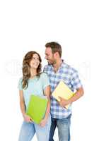 Young couple holding book and folder