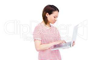 Woman using and typing on laptop