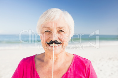 Senior woman with fake mustache
