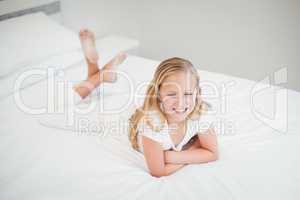 High angle view of girl relaxing on bed