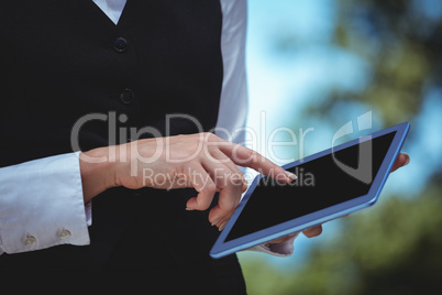 Smiling waitress taking an order with a tablet