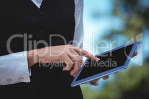 Smiling waitress taking an order with a tablet