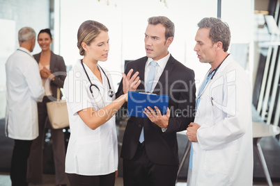 Medical team discussing the report on clipboard