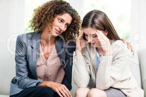 Psychologist counselling depressed woman at home