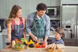 Smiling parents with son in kitchen