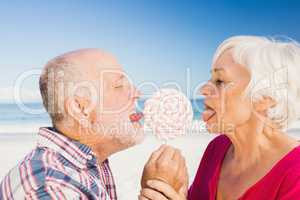Senior couple licking lollipop