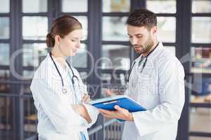 Male doctor discussing with female colleague