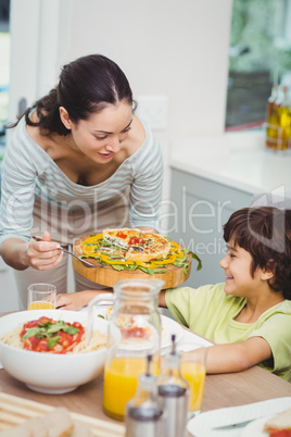 Mother serving food to son