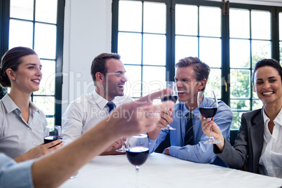 Group of businesspeople toasting wine glass during business lunc