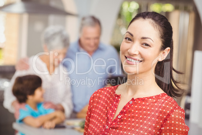 Happy woman with family in kitchen