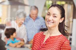 Happy woman with family in kitchen