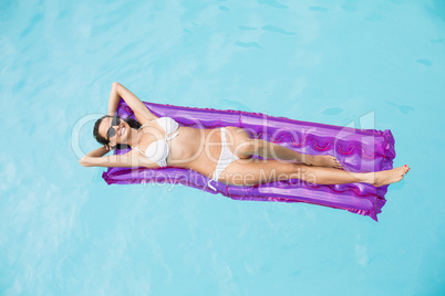 Beautiful woman relaxing on inflatable raft