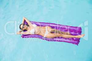 Beautiful woman relaxing on inflatable raft