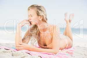 Pretty woman in bikini lying on the beach