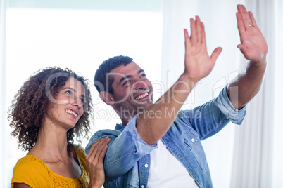 Happy couple planning and gesturing