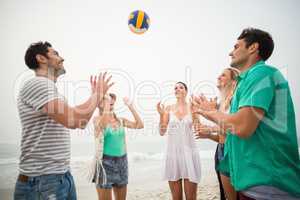 Group of friends playing with a beach ball