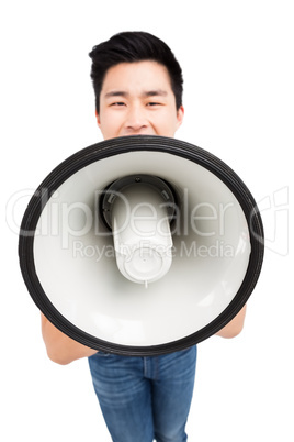 Young man shouting on horn loudspeaker