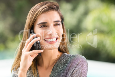 Happy young woman talking on mobile phone