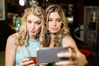 Smiling friends taking a selfie