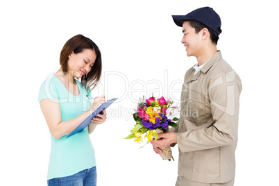 Delivery man delivering flowers to woman