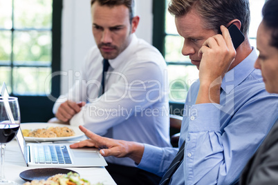 Businessmen discussing during a business lunch meeting