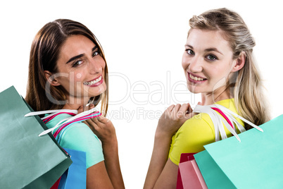 Portrait of smiling female friends holding shopping bags