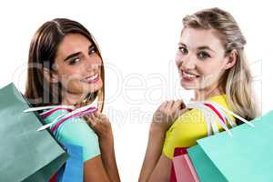 Portrait of smiling female friends holding shopping bags