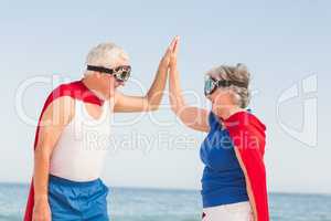 Senior couple wearing superman costume