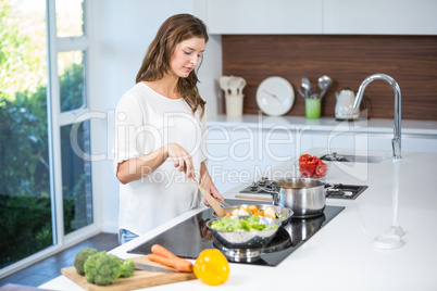 Young woman cooking food