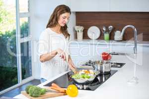 Young woman cooking food