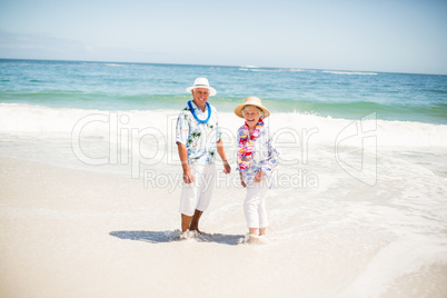 Senior couple standing in the water of the sea