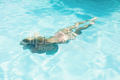Beautiful woman swimming in swimming pool