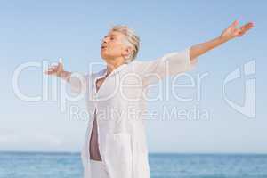 Casual senior woman with arms outstretched