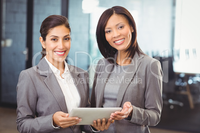Happy businesswomen with digital tablet
