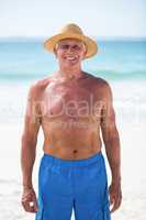 Mature man posing with straw hat